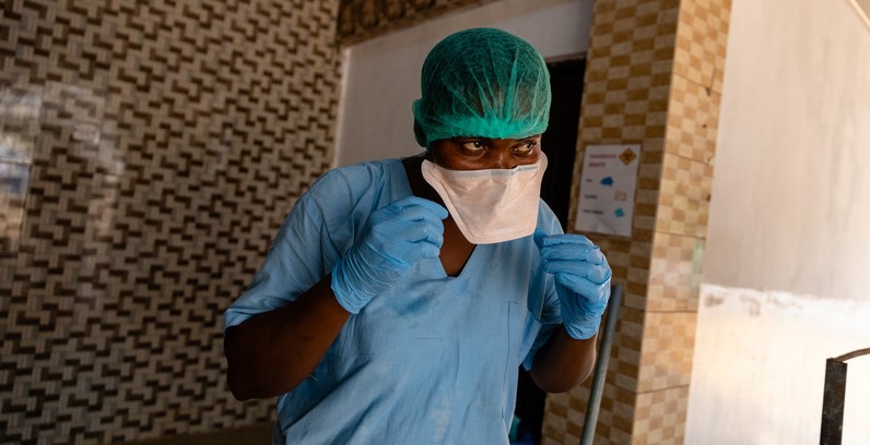 Nurse removes her face mask