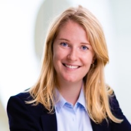 White woman with blonde shoulder length hair smiling